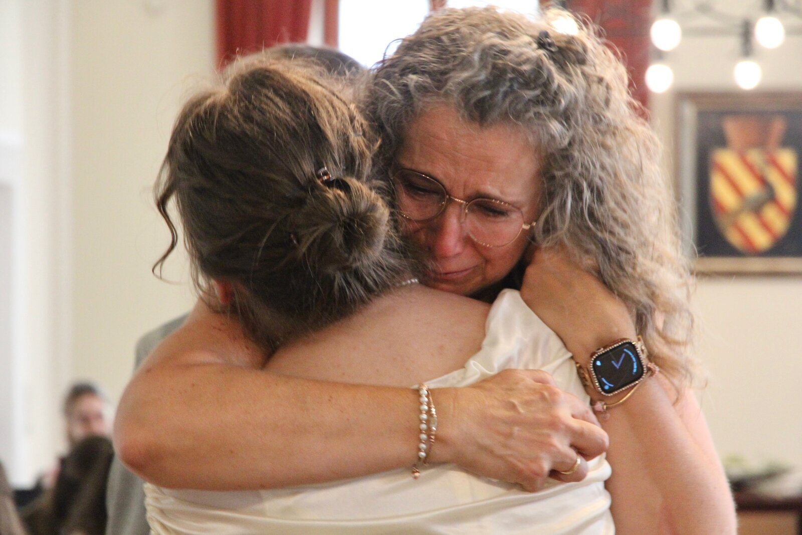 Vanessa sharing a close embrace with a loved one after the ceremony