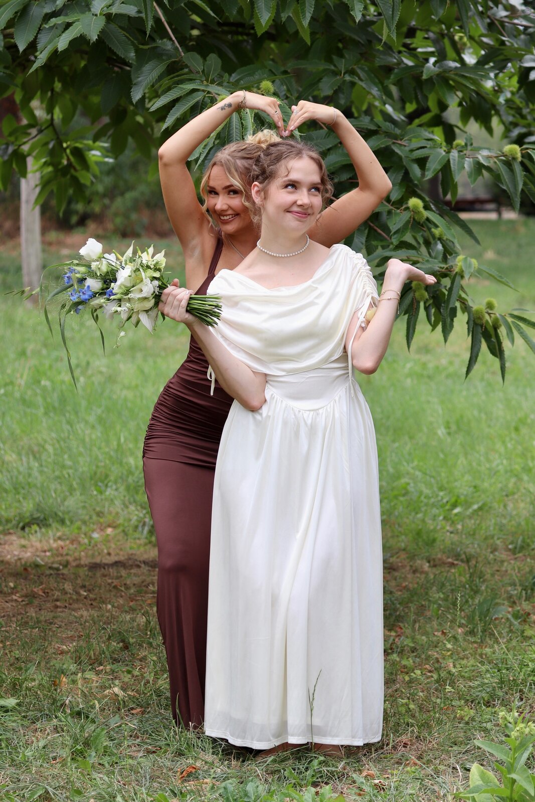 Vanessa and a loved one playfully posing together in the garden