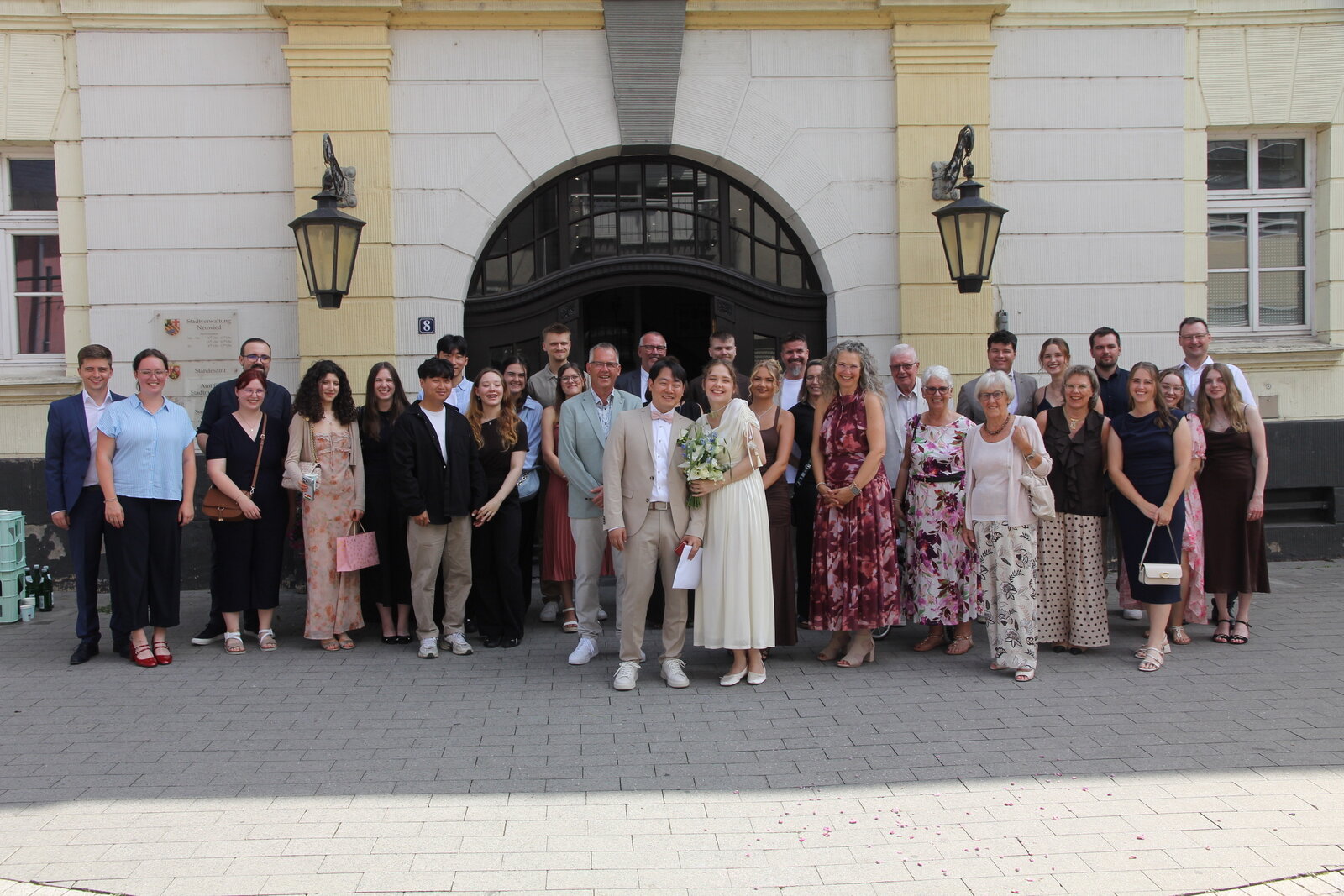 Wedding guests gathered with Yongjai and Vanessa outside the ceremony venue