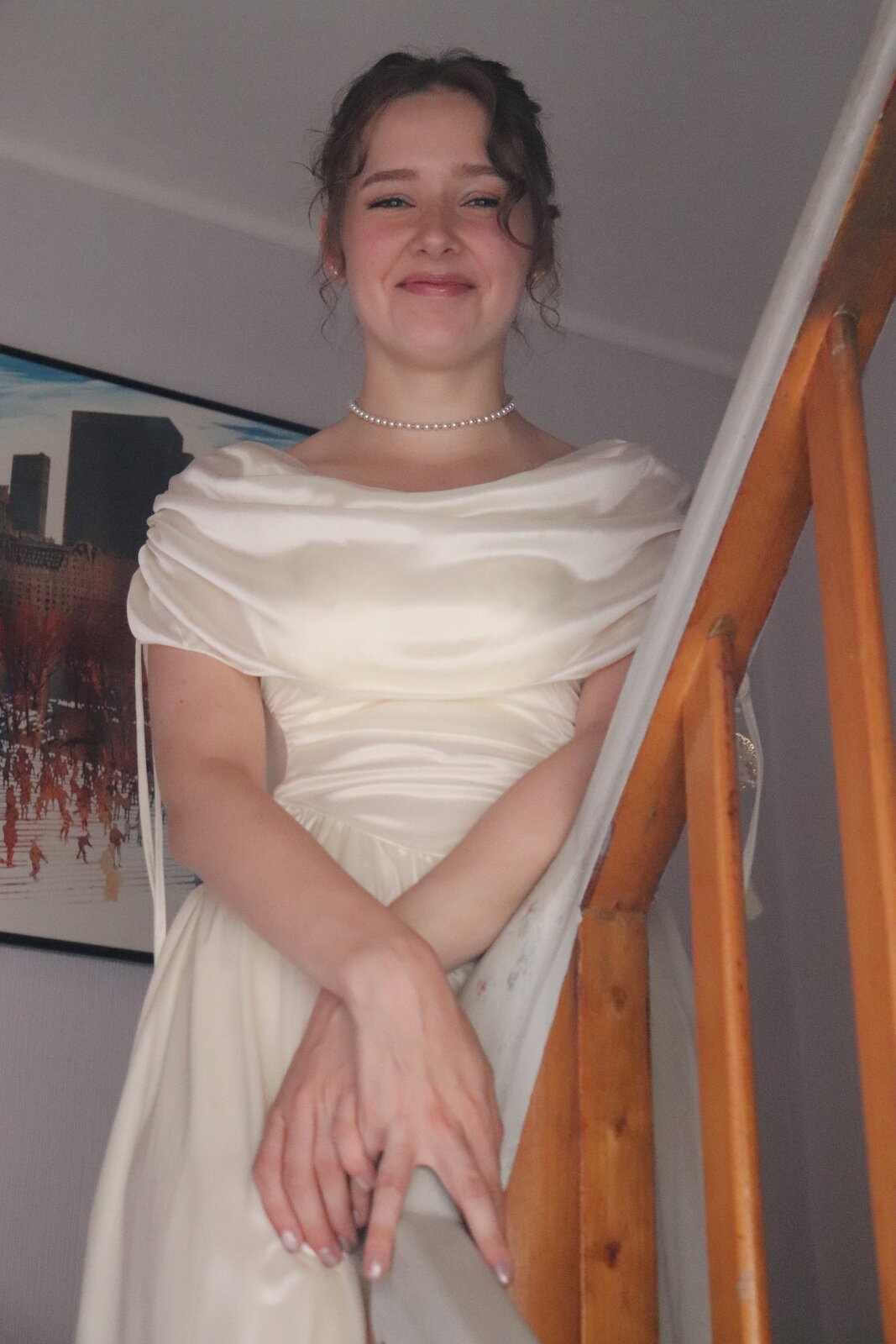 Vanessa smiling on the staircase in her wedding dress